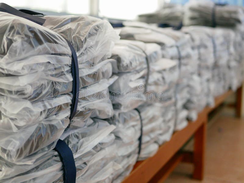 Stacks of Clothes Packed in Plastic Bags Ready To Be Shipped / Distributed Stock Image Image