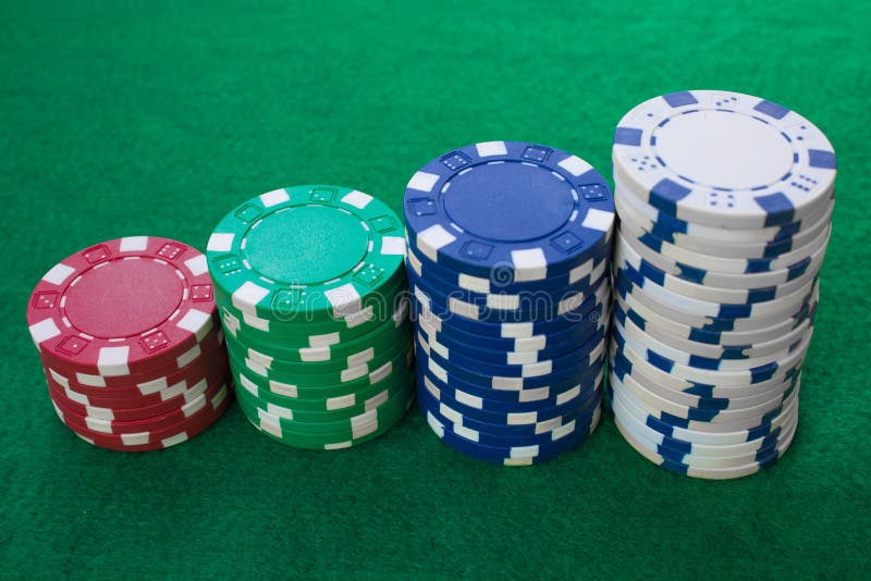 Stacks of poker chips including red, white, green and blue on a green background. Perspective view stock photos Stacks of poker chips including red, white, green and blue on a green background. Perspective view stock photos