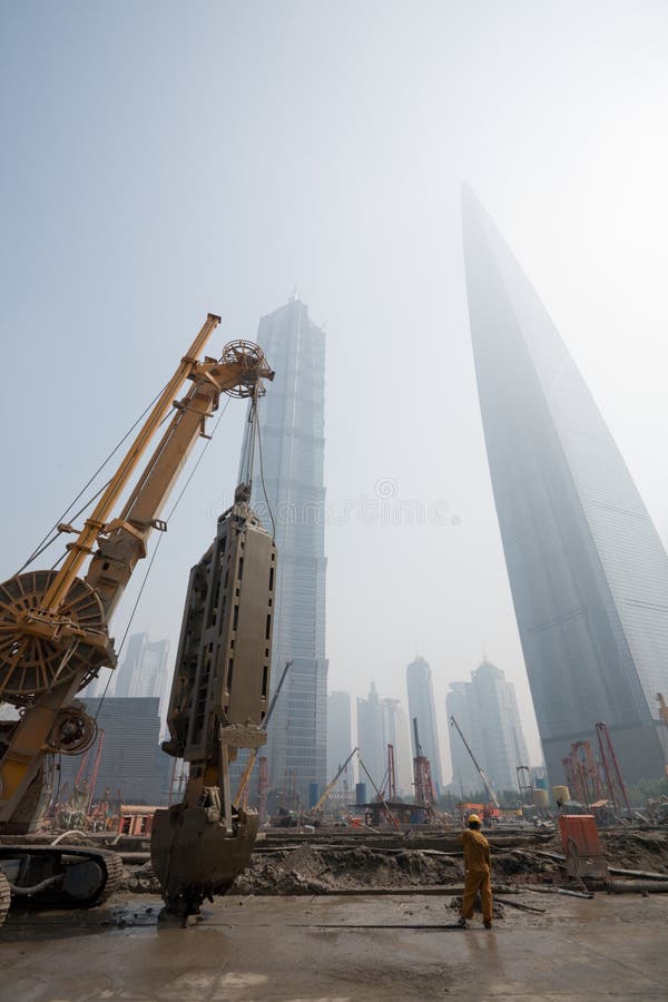 Lujiazui financial & Trade Zone in Shanghai. China. In the foreground the beginning of construction of new office building. June, 2009. Lujiazui financial & Trade Zone in Shanghai. China. In the foreground the beginning of construction of new office building. June, 2009.