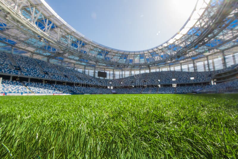 Grass on Stadium in Sunlight. Closeup of a Green Football Field Stock