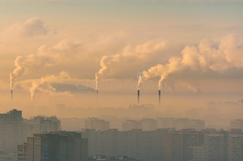 Urban landscape smoked polluted atmosphere from emissions of plants and factories, view of pipes with smoke and residential apartment buildings. Urban landscape smoked polluted atmosphere from emissions of plants and factories, view of pipes with smoke and residential apartment buildings