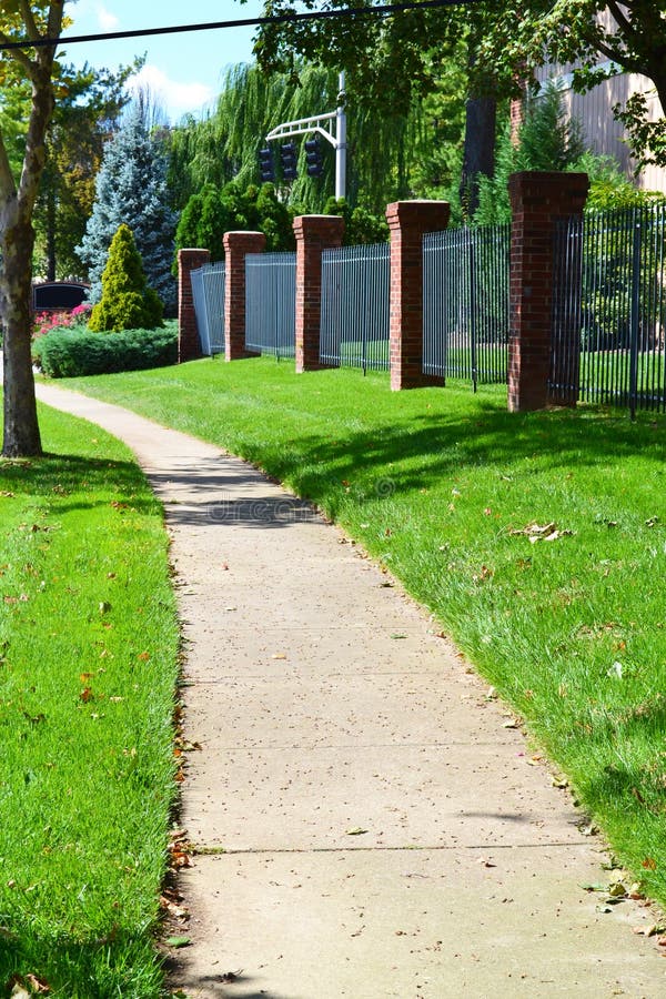 City sidewalk winding through neighborhood. City sidewalk winding through neighborhood