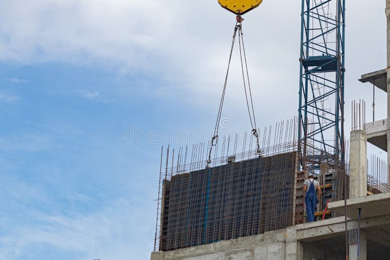 Stage in The Construction of a Multi-Storey Building. Forming The Wall Using the Sliding Formwork. The Lifting Crane Holds the