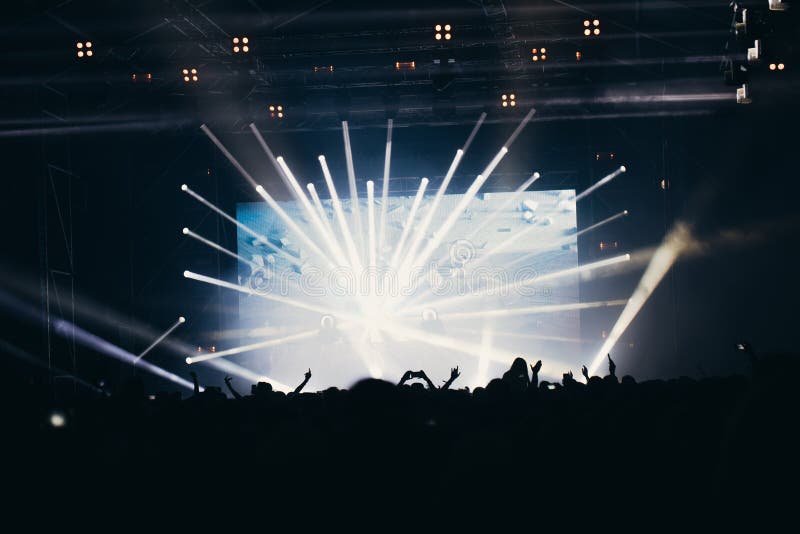 Stage Lights and Crowd of Audience with Hands Raised at a Music ...