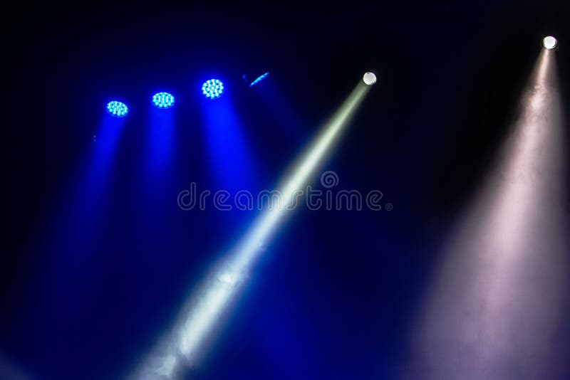 Stage Lights. Several Projectors In The Dark. Multi-colored Light Beams From The Stage Spotlights On The Stage In The Smoke At The