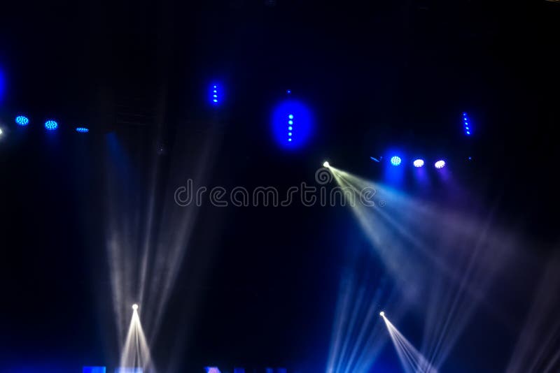 Stage Lights. Several Projectors In The Dark. Multi-colored Light Beams From The Stage Spotlights On The Stage In The Smoke At The