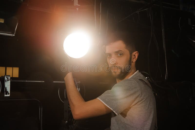 The stage worker sets up the lights. People, festival.