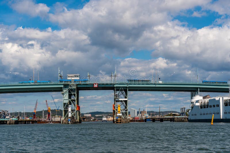 Stagione estiva di Gota Alvbron in Svezia Un ponte stradale con autobus e navi contro il cielo azzurro nuvoloso fotografia stock libera da diritti Stagione estiva di Gota Alvbron in Svezia Un ponte stradale con autobus e navi contro il cielo azzurro nuvoloso fotografia stock libera da diritti