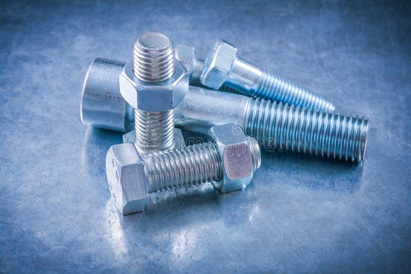 Stainless Bolts and Screwnuts on Scratched Metallic Background Stock