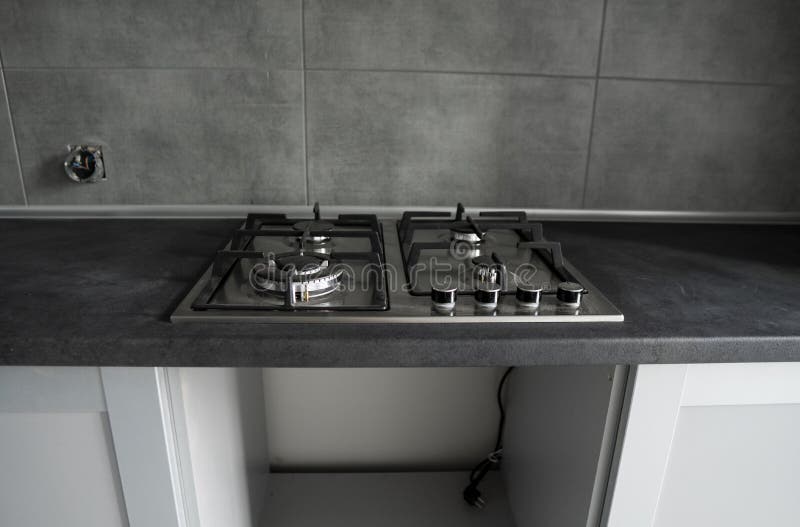 Stainless Grey Metal Kitchen Gas Stove Installed on a the Kitchen with