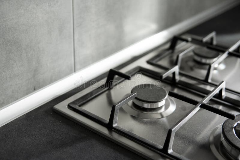 Stainless Grey Metal Kitchen Gas Stove Installed on a the Kitchen with