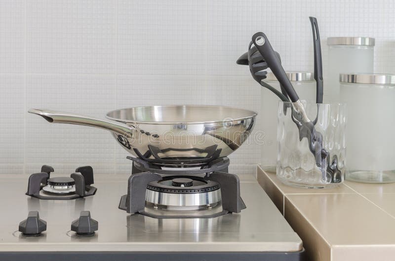 Stainless pan on gas stove stock photo. Image of glass 48329872