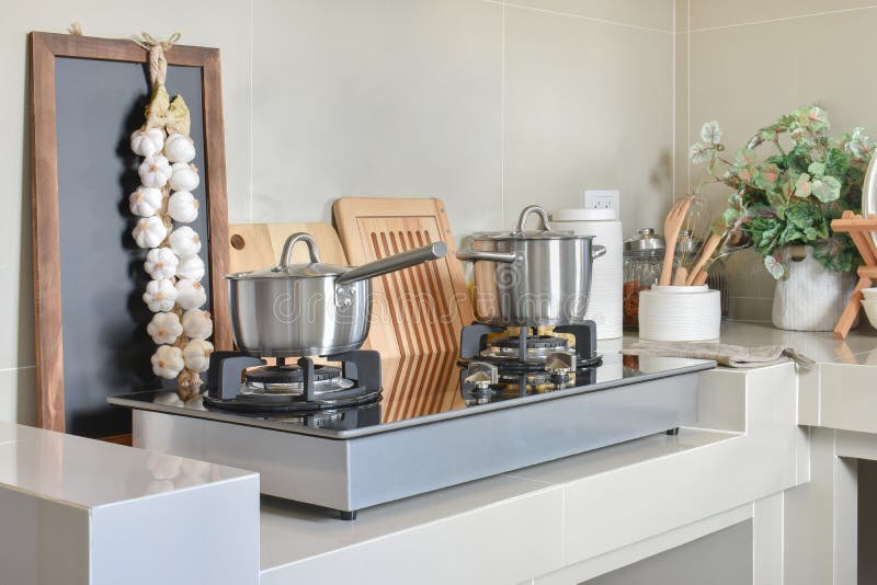 Stainless Pan on Gas Stove with Utensil in Modern Kitchen Stock Photo