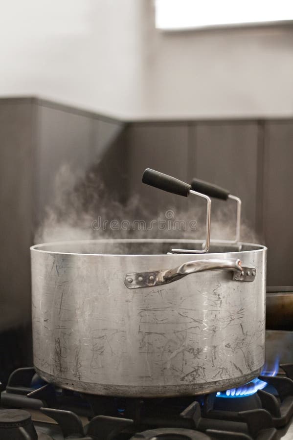 Stainless pan on a stove stock photo
