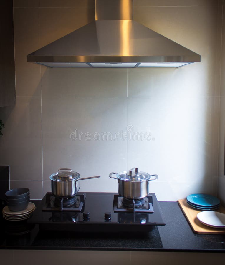 Stainless steel cooking pot on a black gas stove on a kitchen royalty free stock photo Stainless steel cooking pot on a black gas stove on a kitchen royalty free stock photo