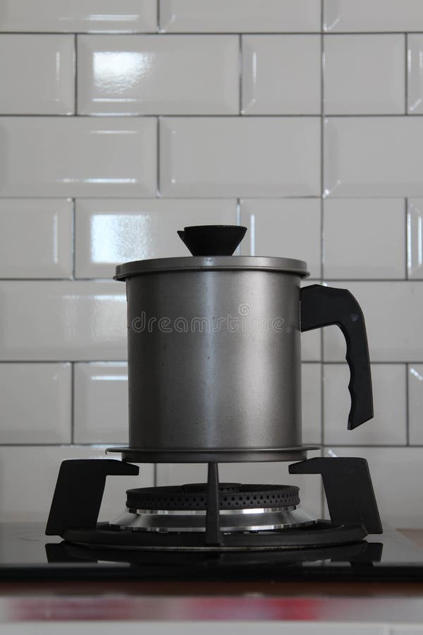 A pot on modern gas stove stock image. Image of kitchenware 237391621