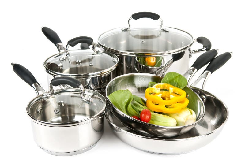 Stainless steel pots and pans with vegetables stock photos