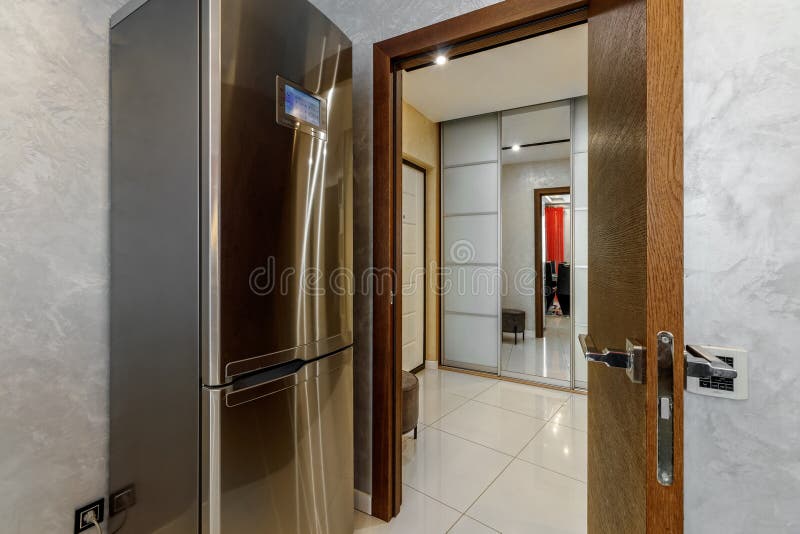 Stainless steel refrigerator with an electronic board with a view of another room