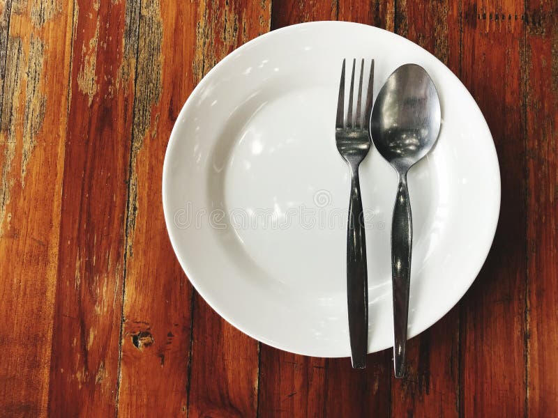 Stainless Steel Spoon and Fork Placed on a White Plate Ready To Eat. Stock Photo Image of dish