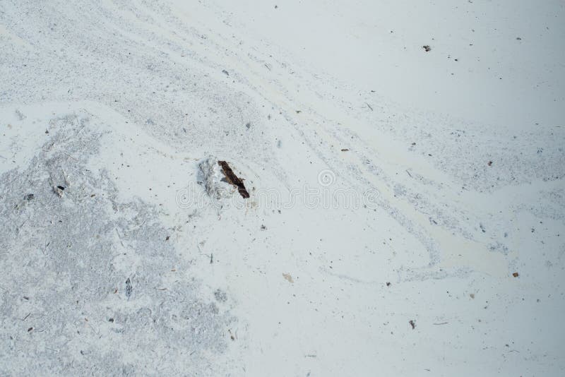 Stains and debris on the surface of the spilled white liquid. Ab