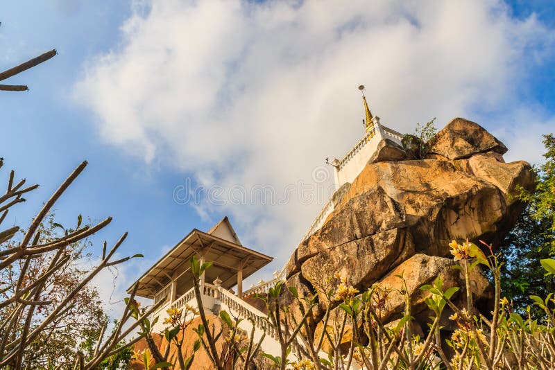 Stair way upward to the golden pagoda on the hill with blue sky background at Wat Khao Rup Chang or Temple of the Elephant Hill, o