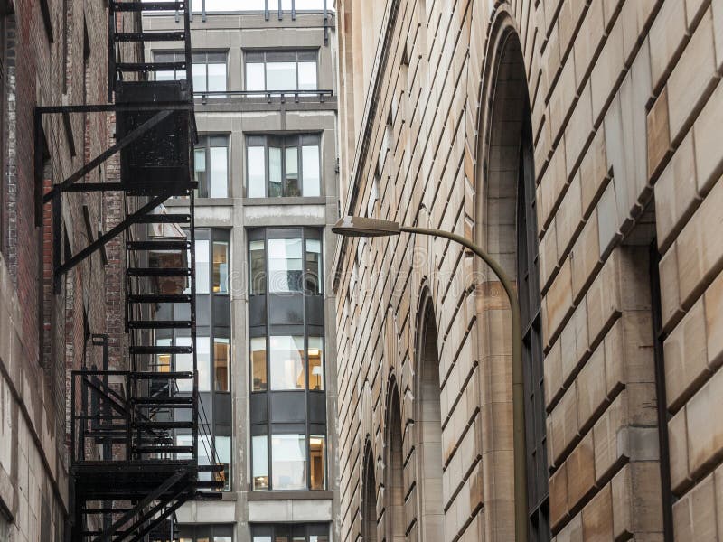 Fire escape stairs and ladder, in metal, on a typical North American old brick building from Montreal, Quebec, Canada. royalty free stock photography Fire escape stairs and ladder, in metal, on a typical North American old brick building from Montreal, Quebec, Canada. royalty free stock photography