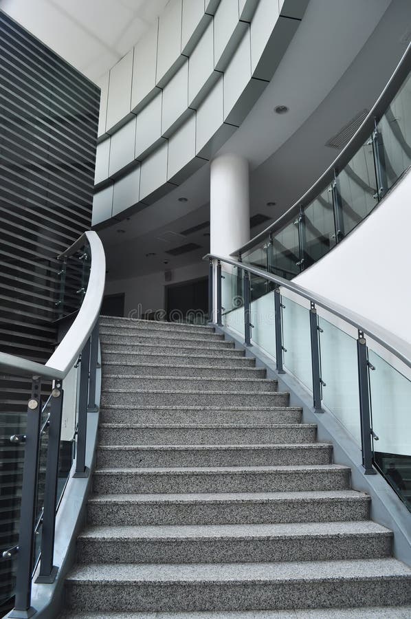 Stairs with glass guardrail in a modern building. Stairs with glass guardrail in a modern building