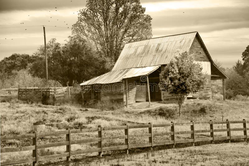 An old barn with fence with a sepia tint. An old barn with fence with a sepia tint.