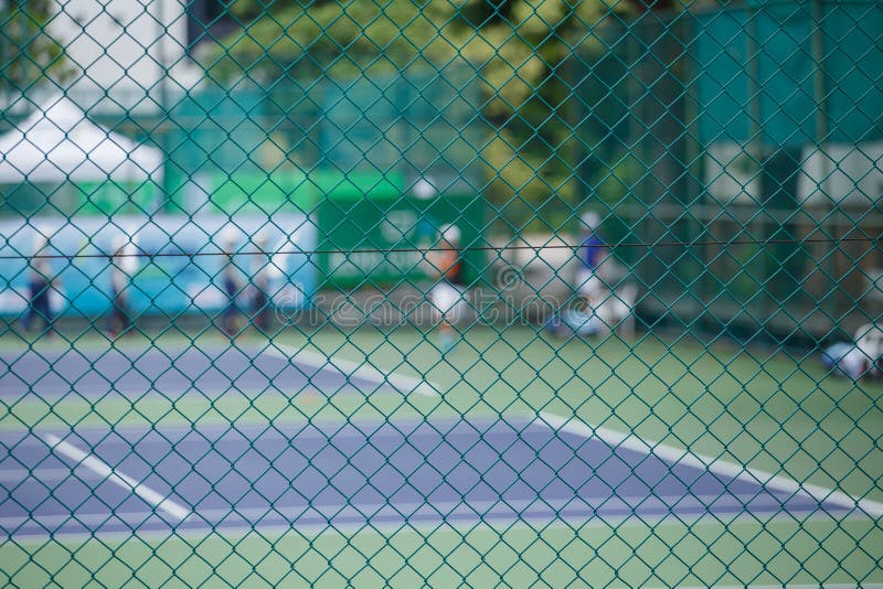 Steel mesh fence of the tennis courts background. Steel mesh fence of the tennis courts background.