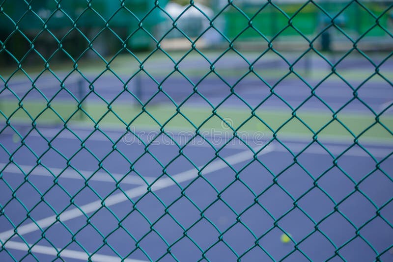 Steel mesh fence of the tennis courts background. Steel mesh fence of the tennis courts background