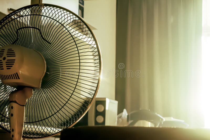 Stand electronic fan in room in morning