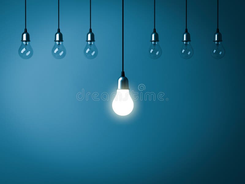 One hanging light bulb glowing with unlit incandescent bulbs on dark blue background