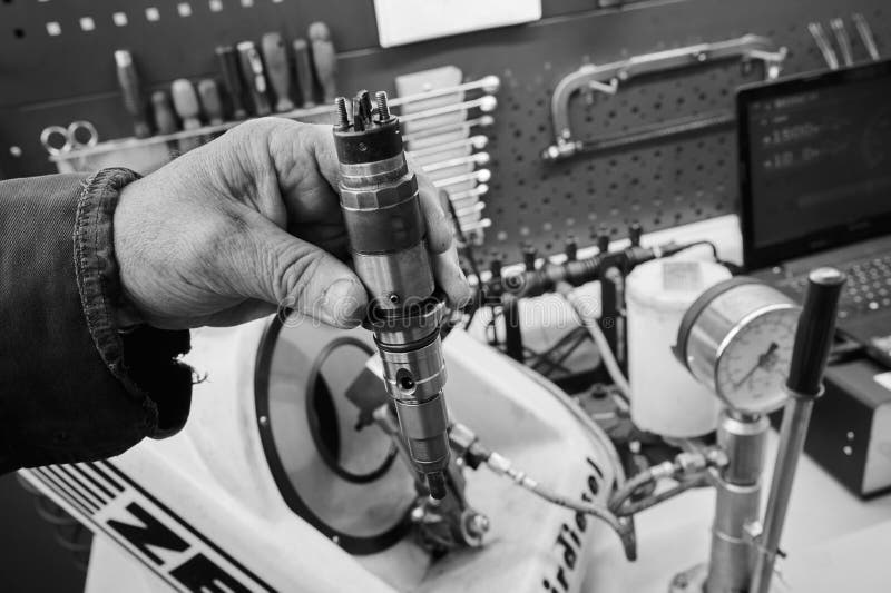 At the stand, the process of checking the operability and wear, the operational properties of the nozzle of a diesel internal stock photo
