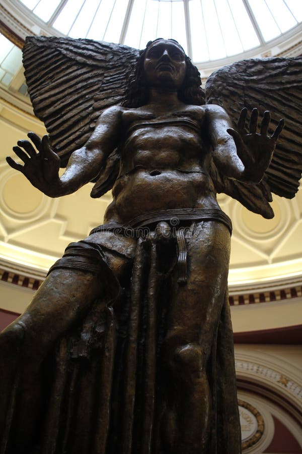 Image of Sir Jacob Epstein's statue of the Archangel Lucifer. The image has been taken from a low angle making it more imposing, the subject reaching down to the onlooker. The slightly under exposed facial features gives a darker almost menacing look to the subject In contrast the light floods down from above, slightly over exposed adding to the context of the story. Image of Sir Jacob Epstein's statue of the Archangel Lucifer. The image has been taken from a low angle making it more imposing, the subject reaching down to the onlooker. The slightly under exposed facial features gives a darker almost menacing look to the subject In contrast the light floods down from above, slightly over exposed adding to the context of the story.