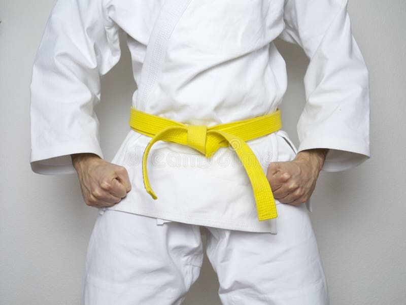 Standing fighter yellow belt centered martial arts white suit