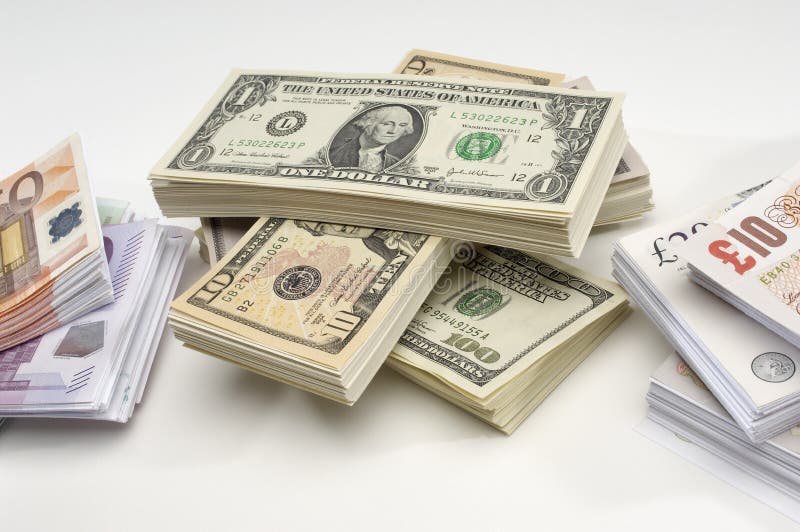 Stack of US, British and European currency over white background. Stack of US, British and European currency over white background