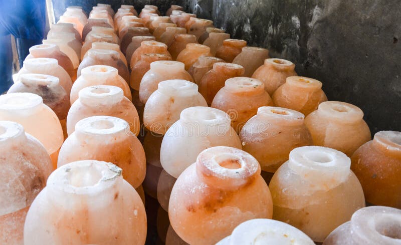 Pile of cup salt lamps. Natural lamps are famous all over the world for their unique beautiful light. These salt lamps emit colorful apricot, yellow & orange light. These are carefully crafted from rock salt taken from mines in Salt Range Mountain located near Quaidabad, Khushab, Pakistan. Natural salt lamps are used to decorate drawing rooms, offices & bedrooms. It ionizes and purifies the air which can be very healthful for asthma & patients with joint pains. Today, the health benefits of ionizers are well recognized; whilst most ionizers in the market are manmade, the crystal salt lamps are Mother Nature`s beautiful alternative. Pile of cup salt lamps. Natural lamps are famous all over the world for their unique beautiful light. These salt lamps emit colorful apricot, yellow & orange light. These are carefully crafted from rock salt taken from mines in Salt Range Mountain located near Quaidabad, Khushab, Pakistan. Natural salt lamps are used to decorate drawing rooms, offices & bedrooms. It ionizes and purifies the air which can be very healthful for asthma & patients with joint pains. Today, the health benefits of ionizers are well recognized; whilst most ionizers in the market are manmade, the crystal salt lamps are Mother Nature`s beautiful alternative.