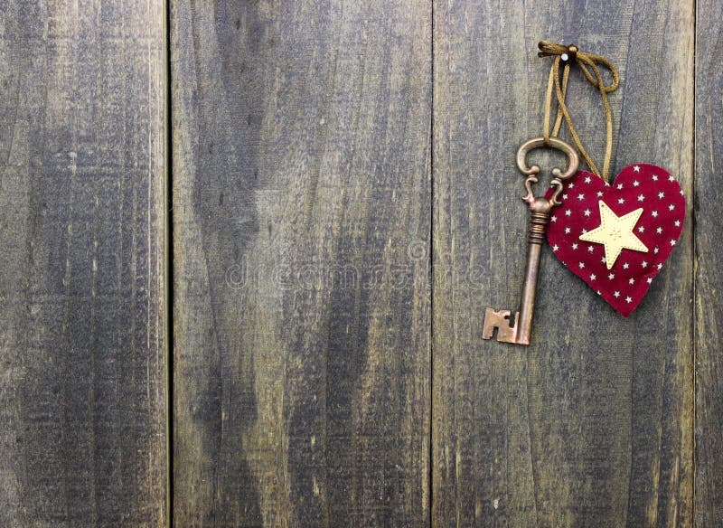 Star heart and antique bronze skeleton key hanging on rustic wood door