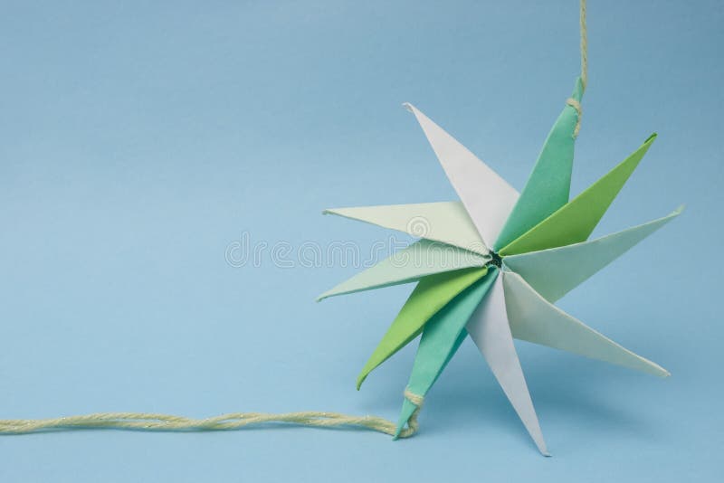 Star shaped paper origami tied by a thread at ends with selective focus. Decagon stock images, royalty-free photos and pictures