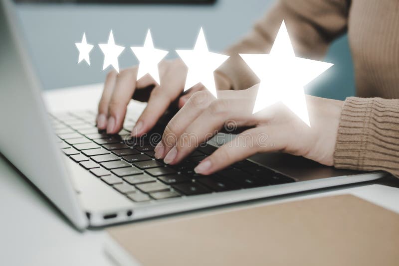 5 star rating. business woman hand working on laptop with five star button on visual screen to review good rating, digital marketi