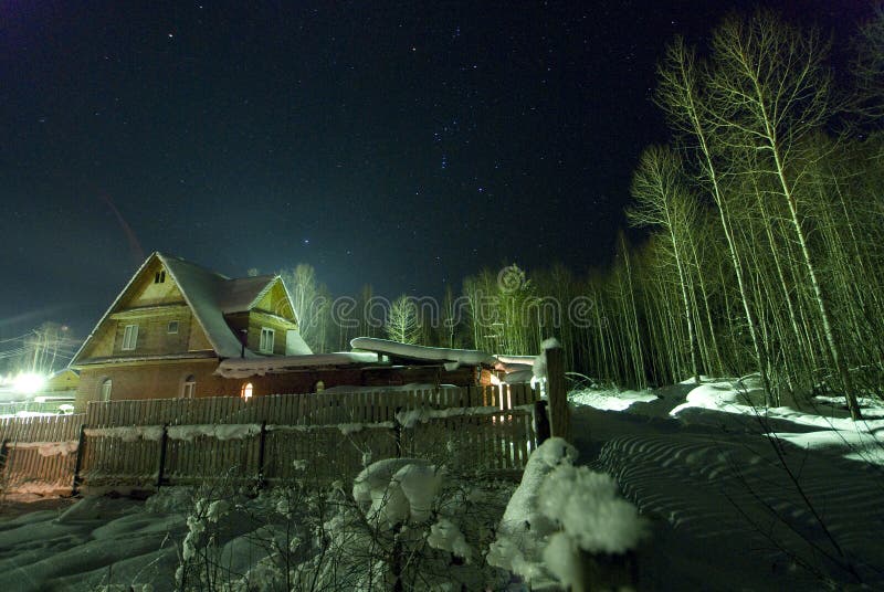 The star sky and Orion over winter village! stock image