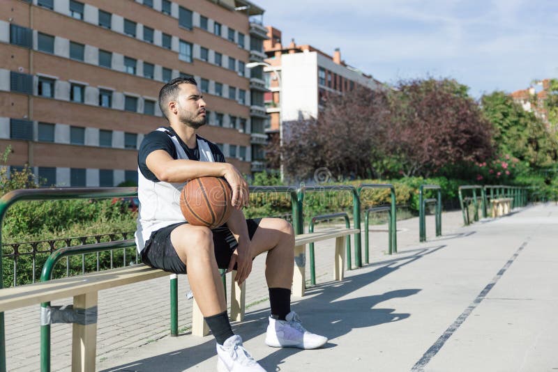 Starker Basketballspieler auf einem städtischen Spielplatz wartet mit seinem Ball auf ein Spiel stockfoto Starker Basketballspieler auf einem städtischen Spielplatz wartet mit seinem Ball auf ein Spiel stockfoto
