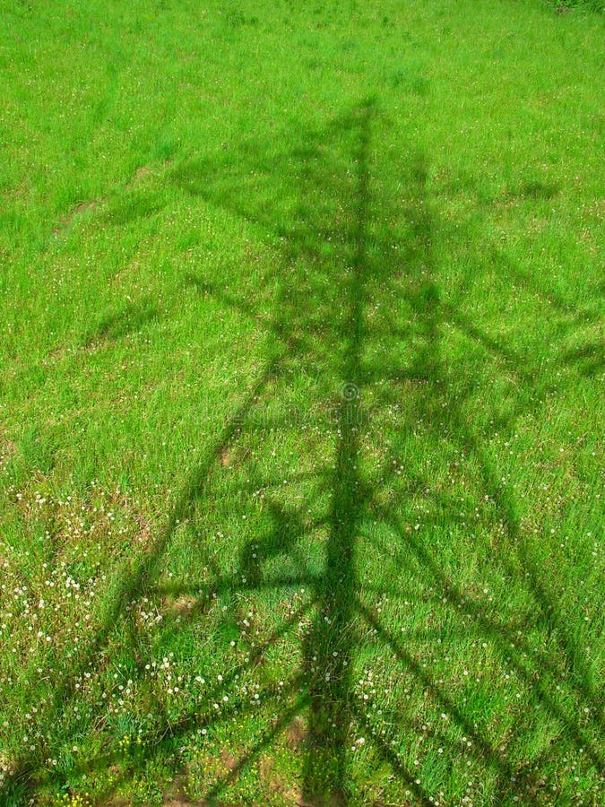 Starkstromleitung. Schatten auf dem Gras lizenzfreie stockfotografie Starkstromleitung. Schatten auf dem Gras lizenzfreie stockfotografie