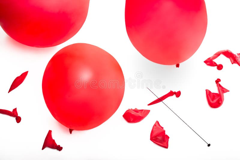 A conceptual image of bursting your bubble illustrated with three red balloons and several balloons popped with a pin. A conceptual image of bursting your bubble illustrated with three red balloons and several balloons popped with a pin.