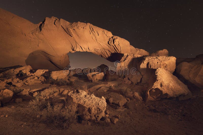 Starry night landscape of a volcanic Rock arch in Tenerife.