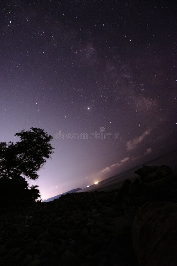 Many different constellations. Starry sky over the sea, the milky way and the lights of the night city. Light in the sky of a. Starry sky over the sea, the milky royalty free stock image Many different constellations. Starry sky over the sea, the milky way and the lights of the night city. Light in the sky of a. Starry sky over the sea, the milky royalty free stock image