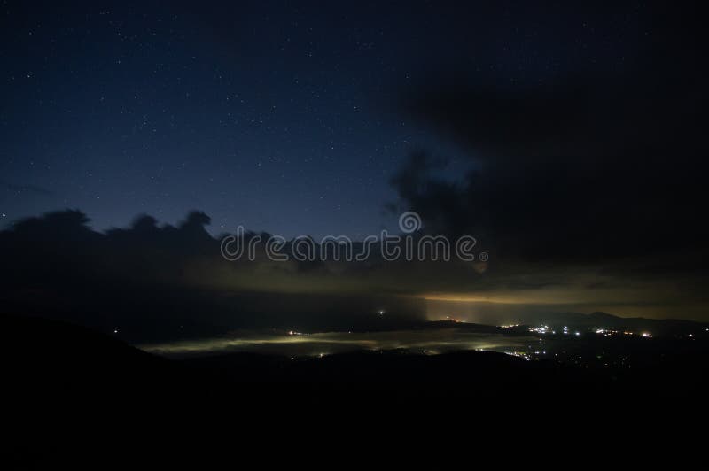 Starry Sky with Rain Clouds and Fog in a Mountain Village Stock Image ...