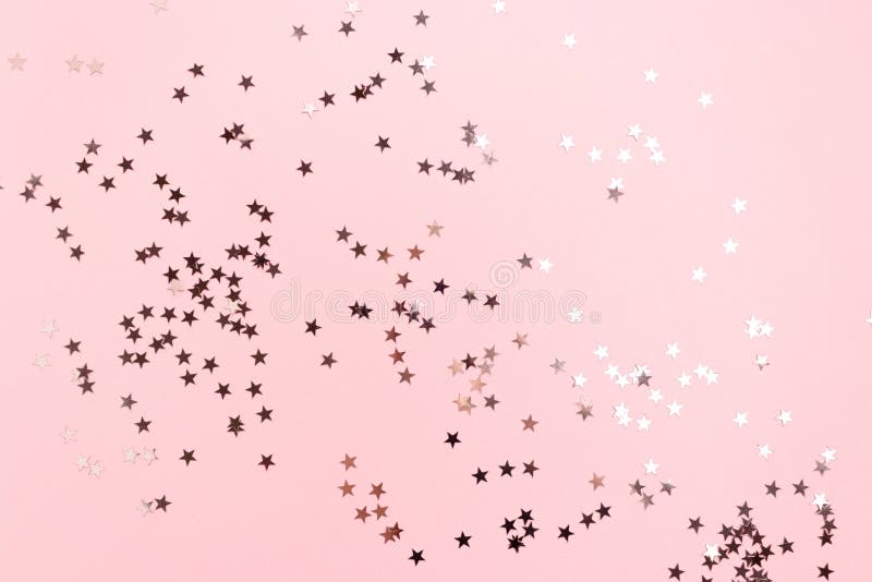 Stars confetti scattered on pink pastel background