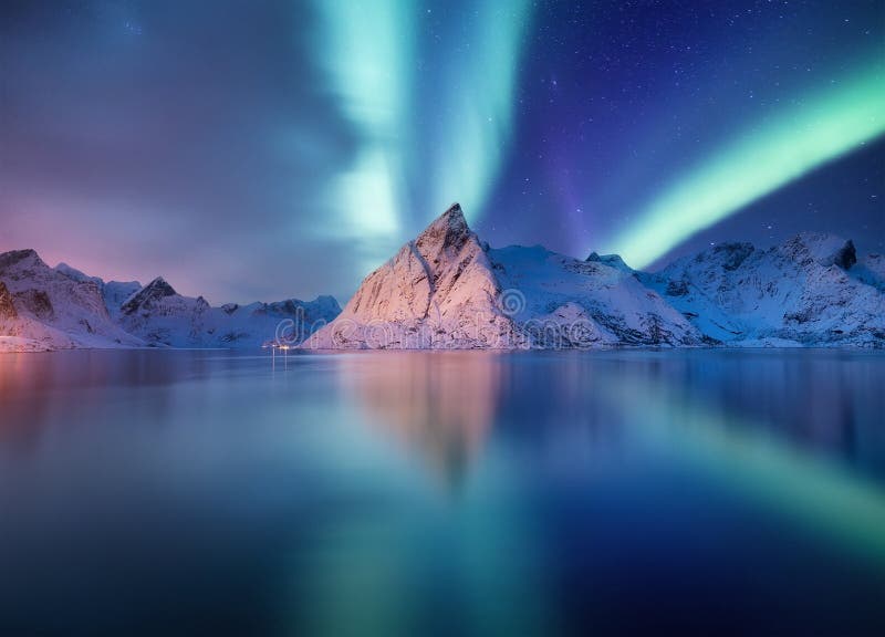 Stars and northern light. Aurora Borealis. Hamnoy village, Lofoten Islands, Norway. Glow on sky. Nature image. Mountains and water