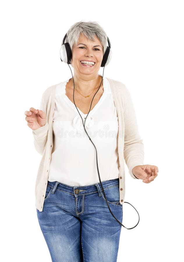 Elderly woman dancing while listen music with headphones, isolated over white background. Elderly woman dancing while listen music with headphones, isolated over white background